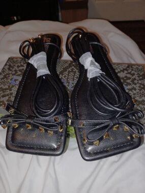 Cape Robbin studded flat sandals feature a square toe design and lace-up straps